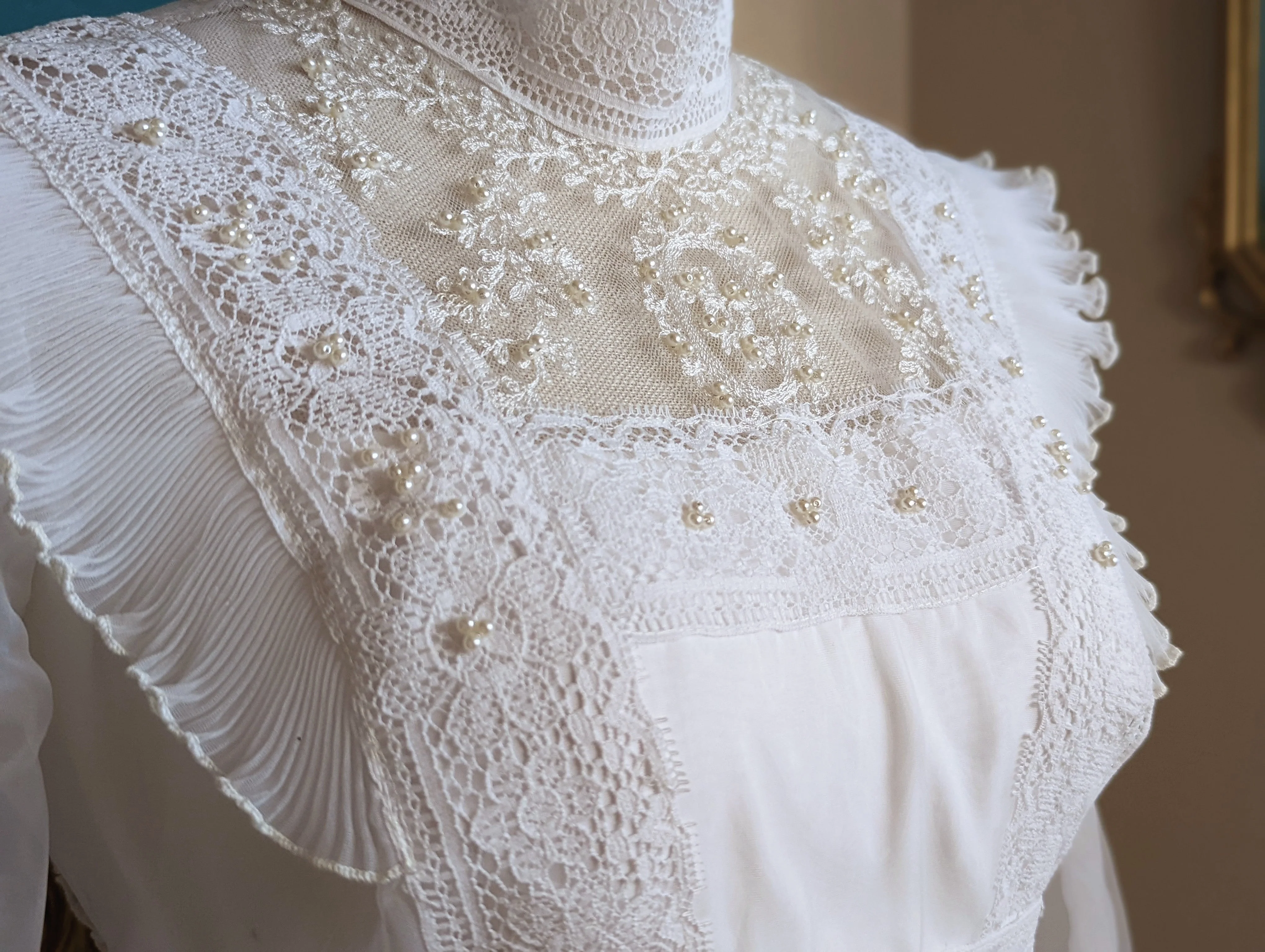 70s Victorian Inspired Bright White Wedding Dress with High Collar Empire Waist, Pleated Shoulder Accents, Detailed Lace, Long Sleeves, and Hand Sewn Beads - Image 10
